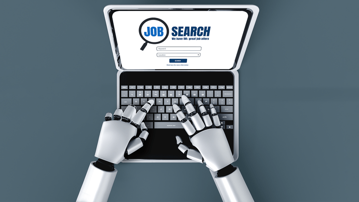 robot hands typing on laptop with screen opened to job search