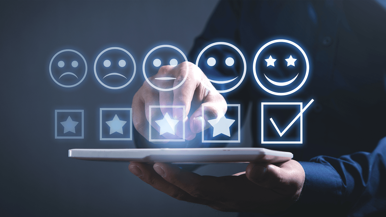 row of stars and emoji faces hovering over laptop