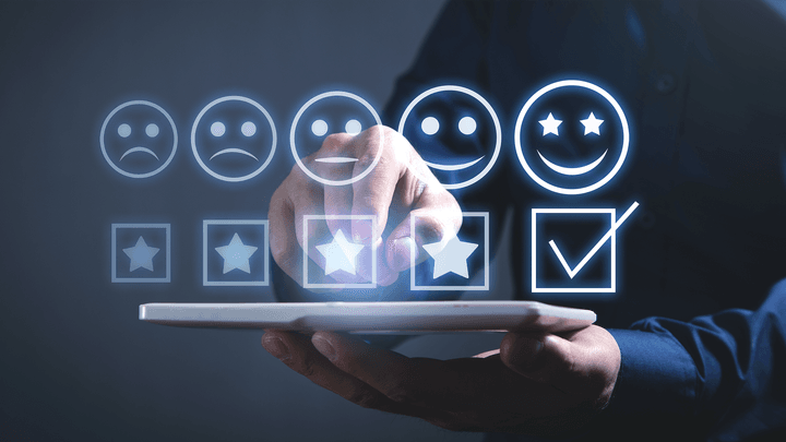 row of stars and emoji faces hovering over laptop