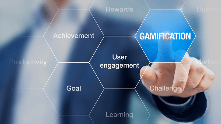 person in business suit in background touching gamification image in foreground