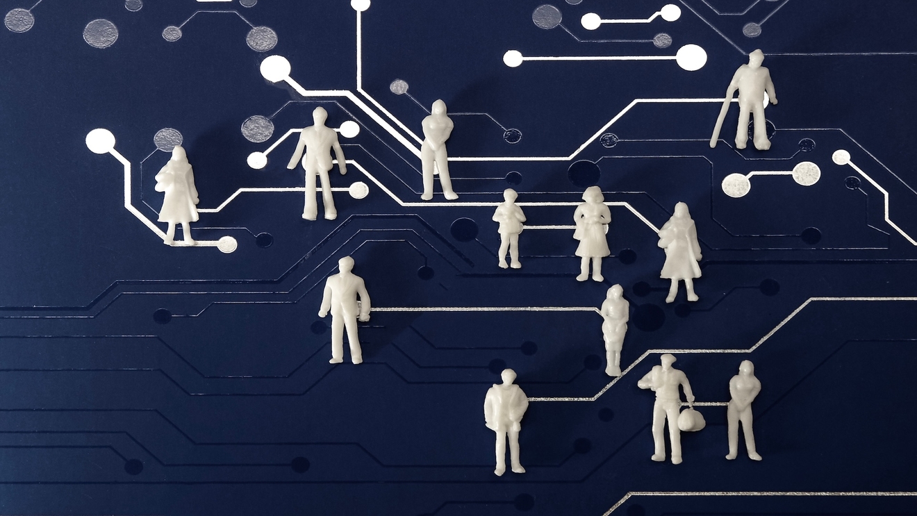 White humanoid figures laid out on a board of circuits all connected, representing cybersecurity career paths