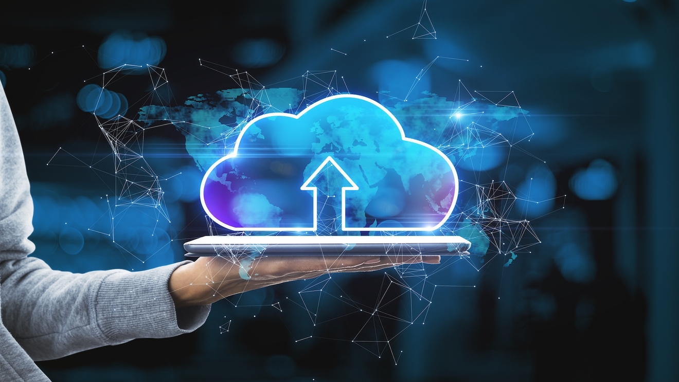 Hand Holding Tablet With Abstract Glowing Cloud Hologram On Blurry Interior Background. Cloud