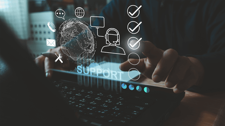 Hands typing on a digital display symbolizing help desk best practices