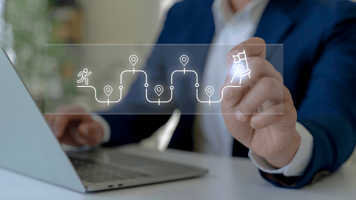 finger choosing icon hovering over laptop