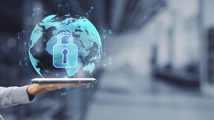 Cybersecurity concept showing a digital lock over a global network on a tablet device